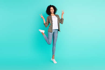 Full length body size view of attractive cheerful girl posing showing v-sign having fun isolated...
