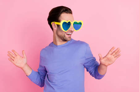 Photo of brunet lovely guy dance look empty space wear spectacles blue pullover isolated on pink color backgroundの写真素材