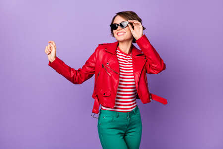 Photo of young attractive girl happy positive smile excited look empty space isolated over violet color backgroundの写真素材