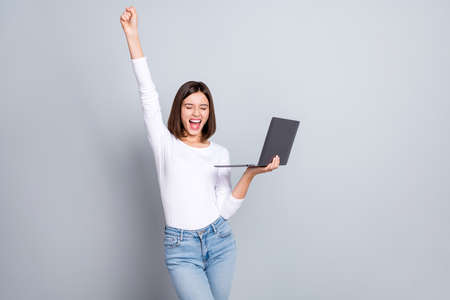 Photo of hooray bob hairstyle ceo lady hold laptop yell wear white pullover isolated on grey color backgroundの写真素材