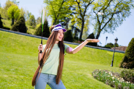 Photo of young cheerful woman happy positive smile play game badminton sportive fly air racquet outdoorsの写真素材