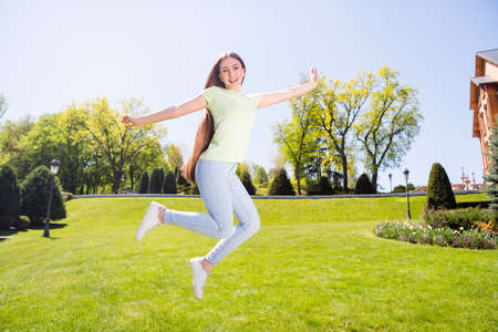 Full length photo of young cheerful excited woman happy positive smile have fun jump up fly air...
