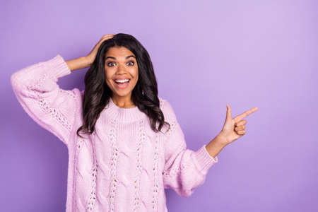 Photo of young excited black girl happy smile amazed surprised promo advert sale isolated over violet color backgroundの写真素材