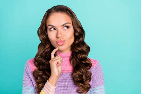 Photo of interested brunette millennial lady look empty space wear violet sweater isolated on teal color backgroundの写真素材