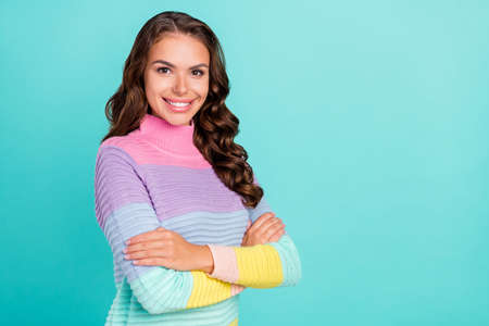 Profile photo of bossy brunette young lady crossed arms wear striped pullover isolated on teal color backgroundの写真素材