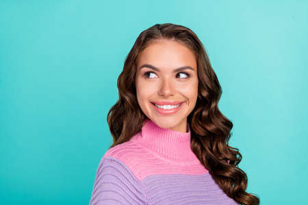 Profile photo of optimistic brunette millennial lady look empty space wear striped pullover isolated on teal color backgroundの写真素材