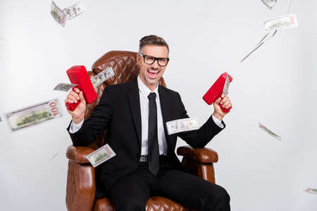 Photo of positive funky young entrepreneur wear black jacket spectacles sitting leather armchair...