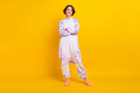 Full length body size photo girl in unicorn costume crossed hands isolated vibrant yellow color backgroundの写真素材