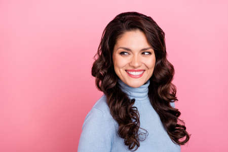 Photo of charming cute lady dressed blue pullover looking back empty space isolated pink color backgroundの写真素材
