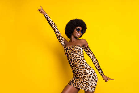 Photo portrait woman wearing leopard dress sunglass dancing at party in summer isolated bright yellow color backgroundの写真素材