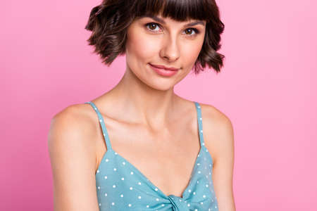 Cropped view portrait of attractive content feminine girl posing isolated over pink pastel color backgroundの写真素材