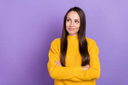 Photo of interested brunette young lady crossed palms look promo wear yellow sweater isolated on purple color backgroundの写真素材