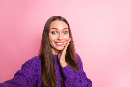 Photo of excited surprised lady make selfie hand cheek wear purple pullover isolated pink color backgroundの写真素材