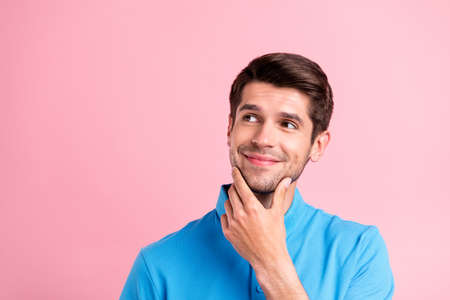 Portrait of young handsome dreamy positive guy look copyspace thinking advertisement isolated on pink color backgroundの写真素材