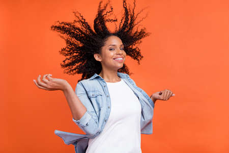 Photo of cool millennial brunette lady wear jeans shirt eyewear isolated on orange color backgroundの写真素材