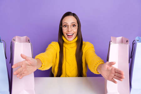 Photo of amazed happy lady open hands hug embrace wear casual pullover shopaholic isolated on violet color backgroundの写真素材