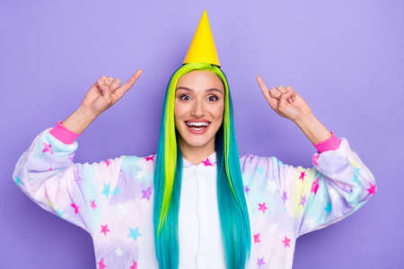 Photo of cheerful promoter lady direct finger cone cap wear kigurumi costume isolated purple color backgroundの写真素材
