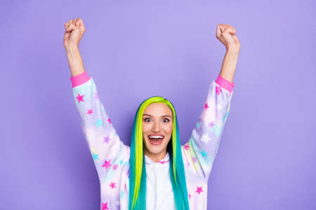 Photo of cheerful successful lady raise fists rejoice goal wear kigurumi costume isolated violet color backgroundの写真素材