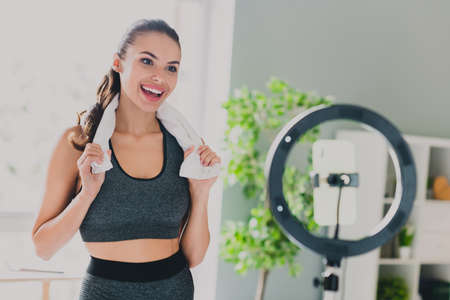 Photo of charming tired young lady wear sport outfit smiling recording online training indoors home houseの写真素材