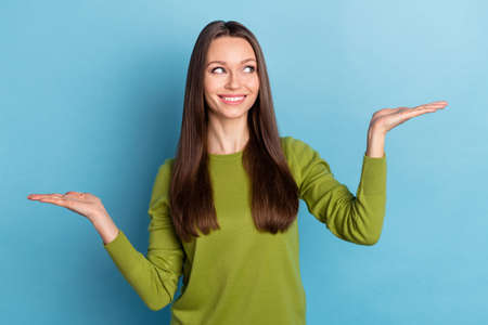 Photo of young cheerful promoter decide choose scales promotion decide isolated over blue color...