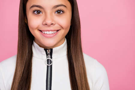 Cropped photo of cute brunette teenager girl wear white pullover isolated on pastel pink color backgroundの写真素材