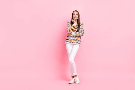 Photo of shiny thoughtful mature lady dressed print pullover arm chin looking empty space smiling isolated pink color backgroundの写真素材