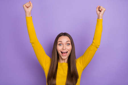 Photo of young cheerful lady rejoice victory fists hands awesome discount yell isolated over violet color backgroundの写真素材