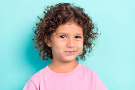 Photo of young attractive little girl childhood happy positive smile isolated over turquoise color backgroundの写真素材