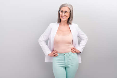 Photo of cute white hairdo elder leader lady look advert wear smart casual spectacles jacket pants isolated on grey color backgroundの写真素材