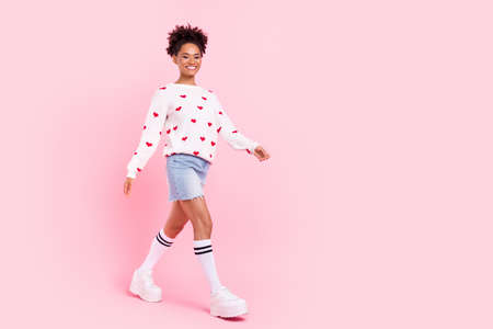 Full length profile side photo of youth charming lady good mood walking weekend isolated over pink color backgroundの写真素材