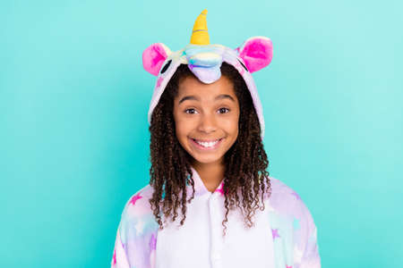 Photo of young excited african girl good mood nightwear sleepover isolated over teal color backgroundの写真素材