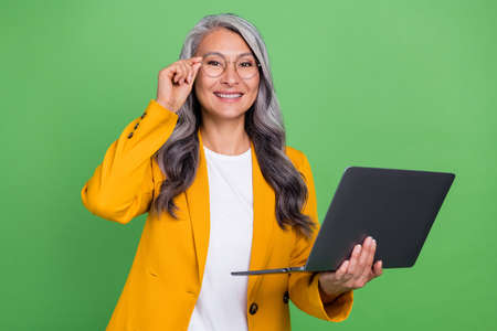 Photo of senior clever lady eyewear use laptop training workshop boss chief isolated over green...