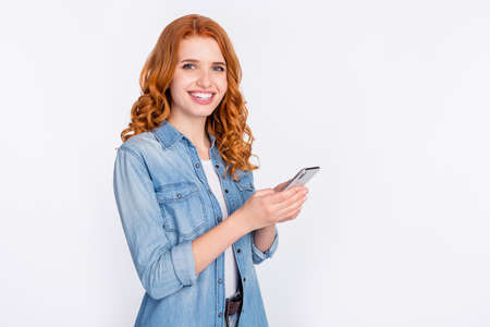 Photo of charming young positive woman smile good mood hold smartphone isolated on grey color...