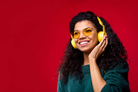 Photo of hipster wavy hairdo lady listen music look empty space wear spectacles green sweater...