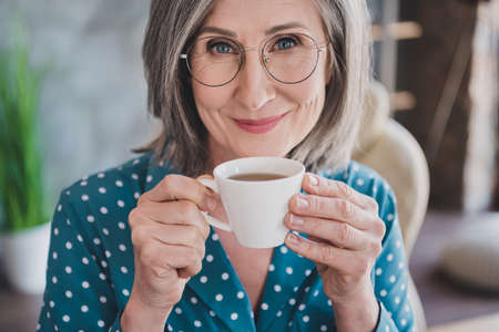 Cropped close-up view portrait of attractive smart cheerful woman drinking espresso at office work...