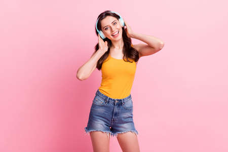 Photo of pretty adorable young lady dressed yellow tank-top singing songs isolated pink color backgroundの写真素材