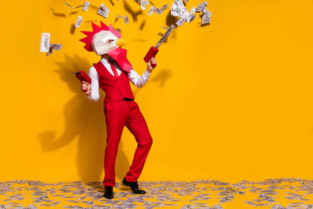 Photo of incognito wacky guy hold usd dropper gun wear cock mask red suit isolated yellow color backgroundの写真素材