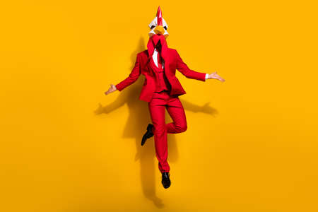 Photo of charismatic animator present best performance wear cock polygonal mask red tux isolated yellow color backgroundの写真素材