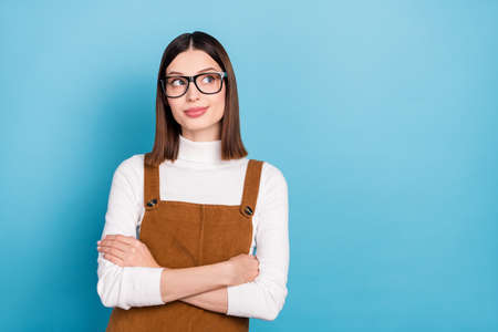 Photo of young pretty girl wondered look empty space eyewear clever isolated over blue color backgroundの写真素材