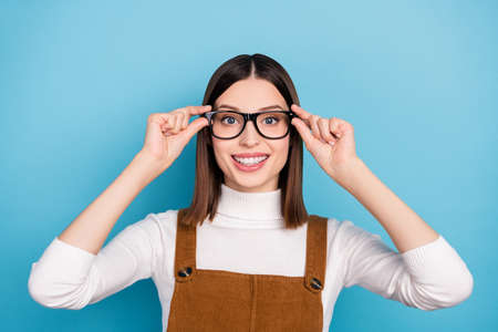 Photo of young charming lady eyewear see health care visit ophthalmologist isolated over blue color backgroundの写真素材