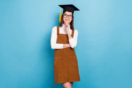 Photo of youth attractive lady arm touch chin look empty space wondered minded isolated over blue color backgroundの写真素材