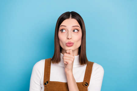 Photo of young charming girl arm touch chin thoughtful look empty space isolated over blue color...