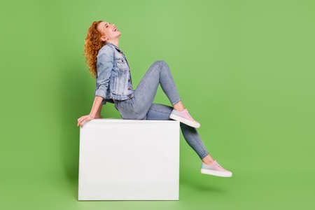 Full size profile side photo of young attractive girl happy positive smile laugh enjoy isolated over green color backgroundの写真素材