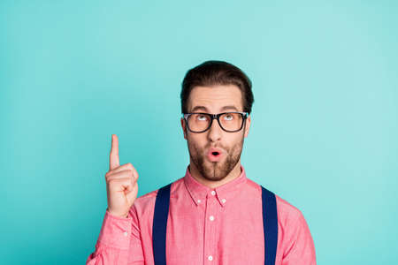 Photo of young excited man amazed surprised creative solution decision choice point finger isolated over teal color backgroundの写真素材