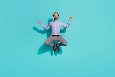 Photo of peaceful sincere office clerk jump meditate lotus pose wear purple shirt isolated teal color backgroundの写真素材