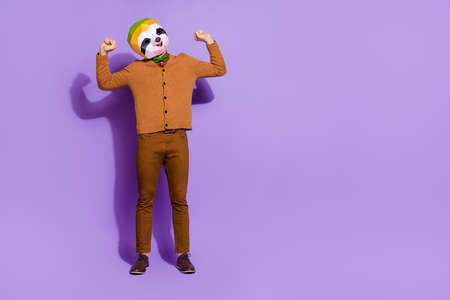 Full body photo of sloth head mask person stretching arms sleepiness isolated on purple color backgroundの写真素材