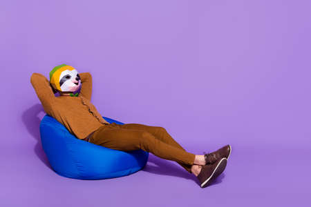 Full size profile side photo of young mant rest longer hands behind head isolated over purple color backgroundの写真素材