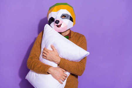 Photo of young guy good mood embrace pillow sleepy early red panda isolated over purple color backgroundの写真素材