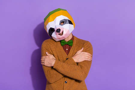 Photo of young man good mood embrace himself authentic look incognito isolated over violet color backgroundの写真素材