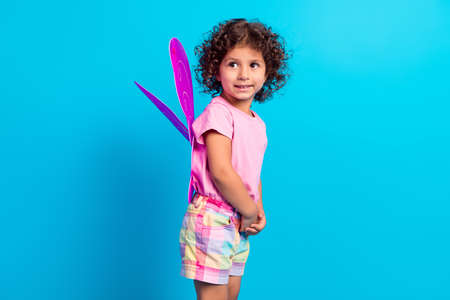 Profile side view of attractive cheerful girl wearing butterfly wings isolated over bright blue color backgroundの写真素材